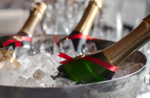 An image of champagne cooling off in a printed ice bucket